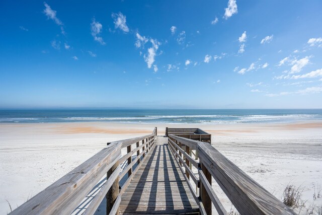 view of home's community featuring a water view and a view of the beach