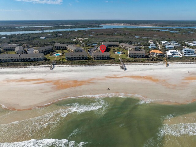 aerial view with a water view and a view of the beach