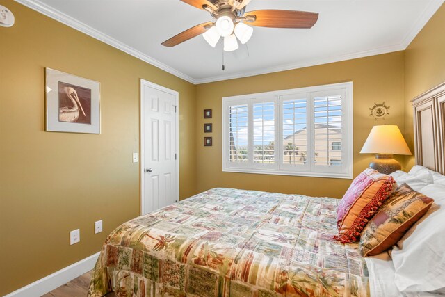 bedroom with ceiling fan, baseboards, and crown molding