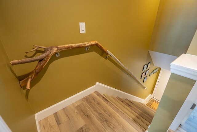 stairs featuring wood finished floors