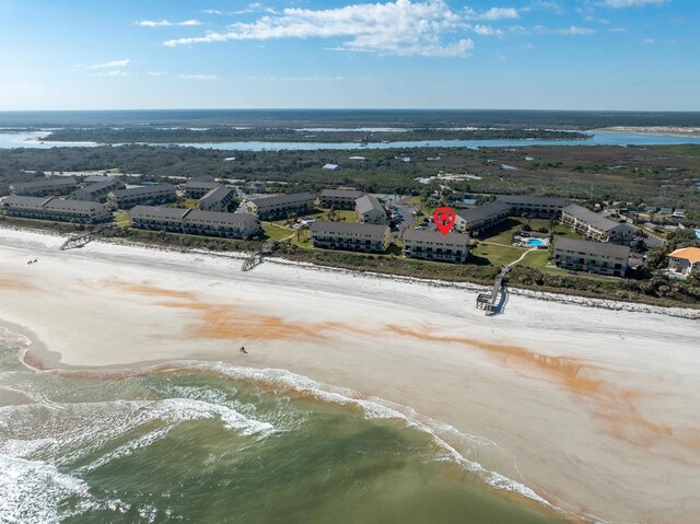 drone / aerial view featuring a beach view and a water view