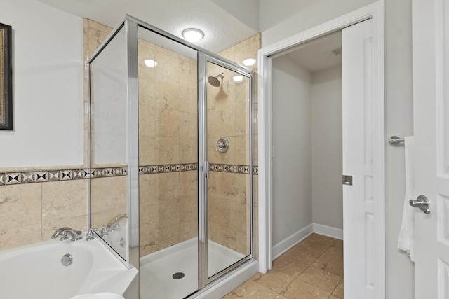 bathroom featuring separate shower and tub