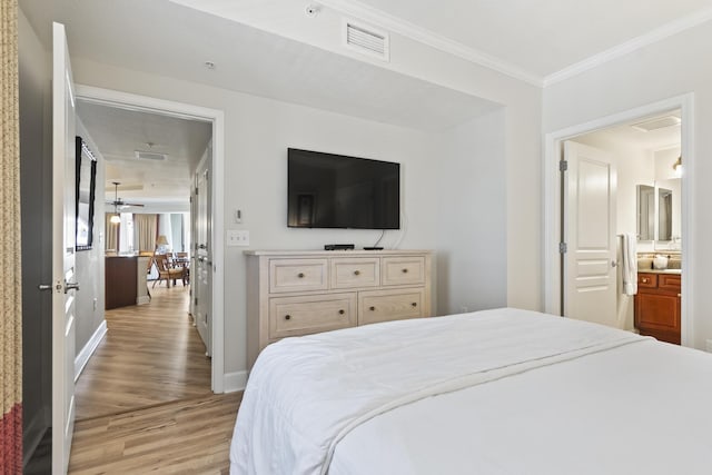 bedroom with crown molding and light hardwood / wood-style flooring