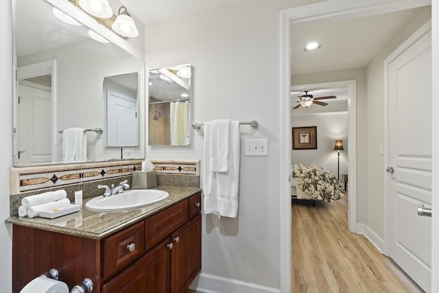 bathroom featuring vanity, wood-type flooring, ceiling fan, and a shower with shower curtain