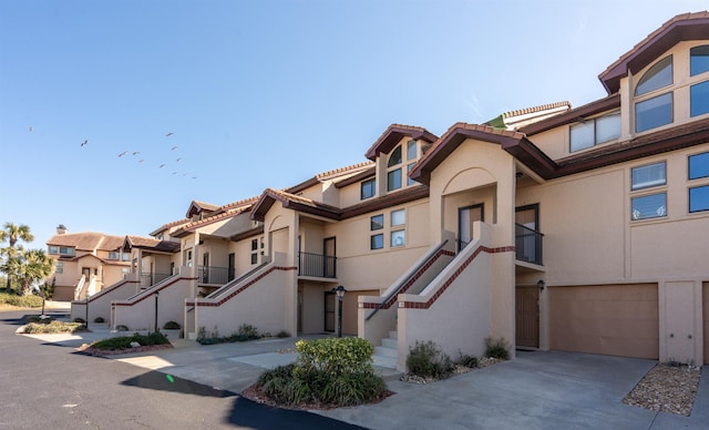8200 S A1A Unit 15, Saint Augustine, FL 32080 - view of property featuring stairway, driveway, a garage, and a residential view