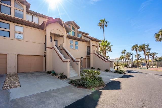 8200 S A1A Unit 15, Saint Augustine, FL 32080 - view of front of property featuring stucco siding, an attached garage, and concrete driveway