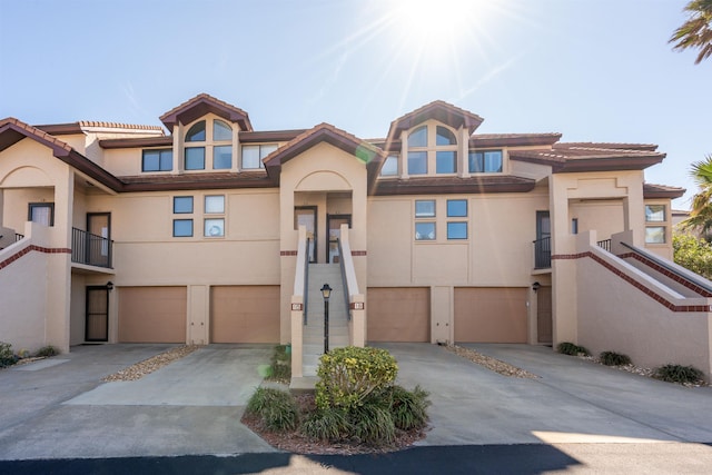 8200 S A1A Unit 15, Saint Augustine, FL 32080 - multi unit property featuring stucco siding, a garage, driveway, and a tile roof