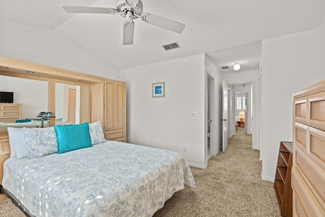 8200 S A1A Unit 15, Saint Augustine, FL 32080 - bedroom with light colored carpet, a textured ceiling, lofted ceiling, and ceiling fan