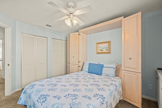 8200 S A1A Unit 15, Saint Augustine, FL 32080 - carpeted bedroom with multiple closets, a textured ceiling, and ceiling fan
