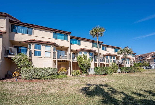 8200 S A1A Unit 15, Saint Augustine, FL 32080 - view of front of house with stucco siding, a front lawn, and a residential view