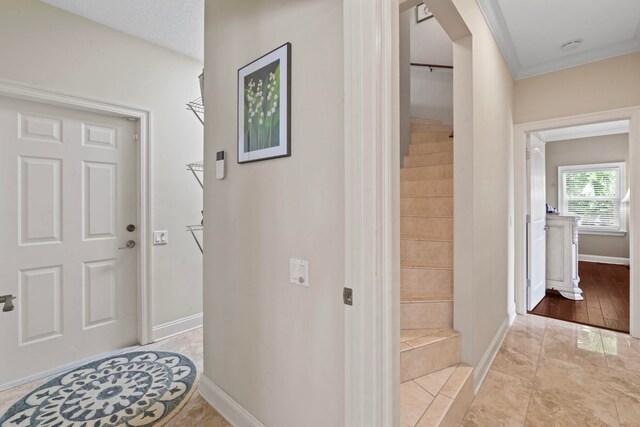 821 Kalli Creek Ln, Saint Augustine, FL 32080 - entryway with baseboards, ornamental molding, and stairway