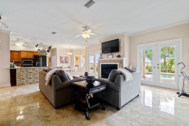 821 Kalli Creek Ln, Saint Augustine, FL 32080 - living room featuring a ceiling fan, crown molding, healthy amount of natural light, a fireplace, and french doors