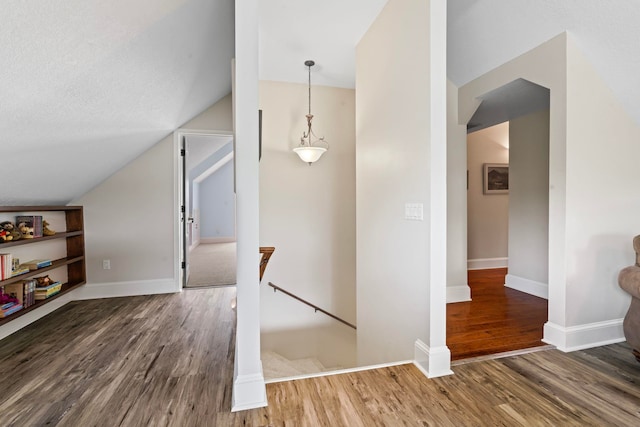 821 Kalli Creek Ln, Saint Augustine, FL 32080 - hallway with an upstairs landing, wood finished floors, lofted ceiling, and baseboards