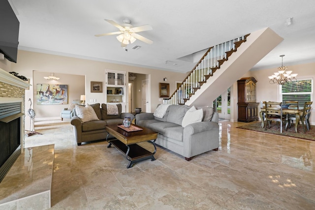821 Kalli Creek Ln, Saint Augustine, FL 32080 - living room with crown molding, a chandelier, stairs, a fireplace with flush hearth, and ceiling fan