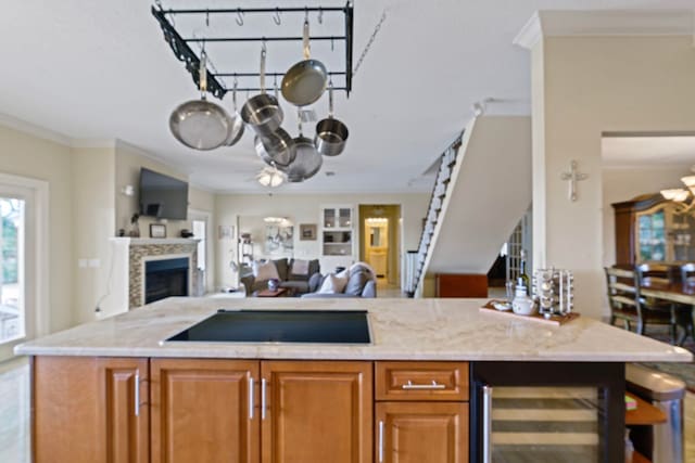 821 Kalli Creek Ln, Saint Augustine, FL 32080 - kitchen featuring open floor plan, black electric stovetop, wine cooler, a fireplace, and light stone counters