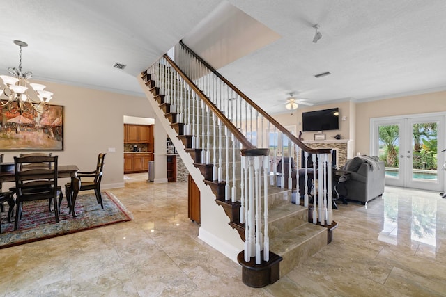 821 Kalli Creek Ln, Saint Augustine, FL 32080 - stairs featuring ornamental molding, marble look tiles, a fireplace, a ceiling fan, and a chandelier