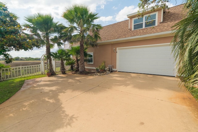 821 Kalli Creek Ln, Saint Augustine, FL 32080 - view of front of house with stucco siding, concrete driveway, and roof with shingles