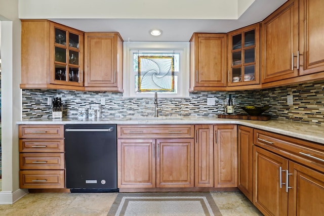 821 Kalli Creek Ln, Saint Augustine, FL 32080 - kitchen featuring black dishwasher, a sink, brown cabinetry, decorative backsplash, and light stone countertops