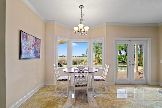 821 Kalli Creek Ln, Saint Augustine, FL 32080 - dining area featuring healthy amount of natural light, a chandelier, baseboards, french doors, and ornamental molding