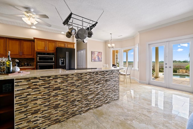 821 Kalli Creek Ln, Saint Augustine, FL 32080 - kitchen with black appliances, brown cabinets, a chandelier, ornamental molding, and french doors