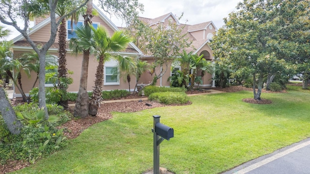 821 Kalli Creek Ln, Saint Augustine, FL 32080 - obstructed view of property featuring a front yard and stucco siding