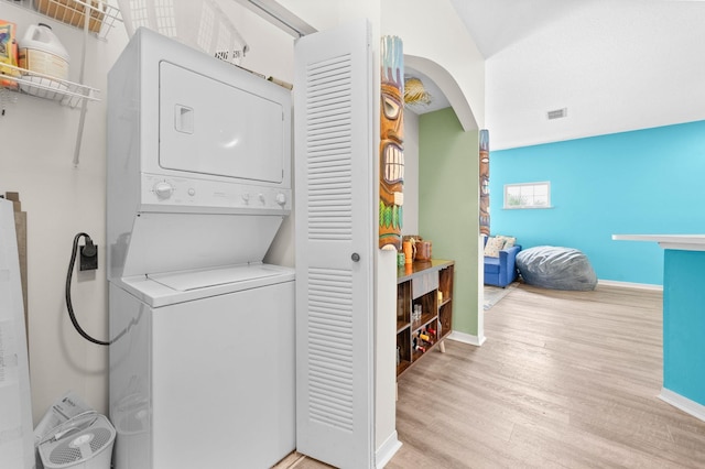 510 Florida Club Blvd Unit 301, Saint Augustine, FL 32084 - laundry room with estacked washer and dryer, wood finished floors, arched walkways, and baseboards