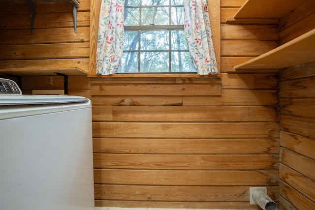 laundry room with washer / clothes dryer and wood walls