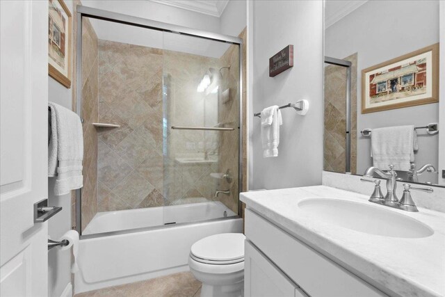 587 Pescado Dr, Saint Augustine, FL 32095 - full bath with ornamental molding, vanity, bath / shower combo with glass door, and tile patterned flooring
