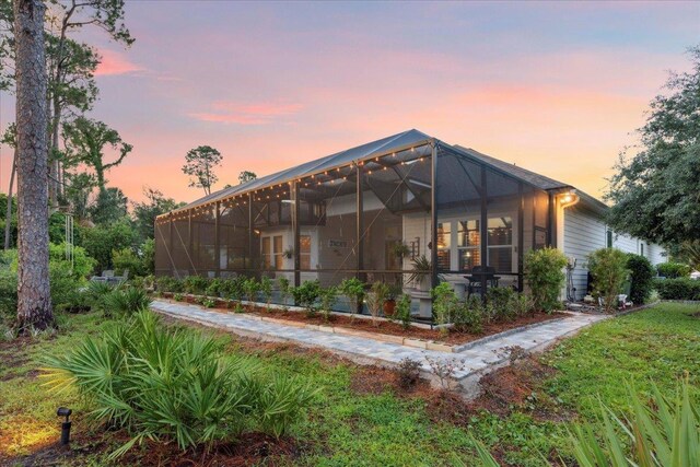 587 Pescado Dr, Saint Augustine, FL 32095 - back of house at dusk with glass enclosure