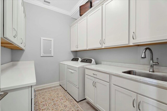 587 Pescado Dr, Saint Augustine, FL 32095 - laundry room featuring cabinet space, washer and clothes dryer, and crown molding