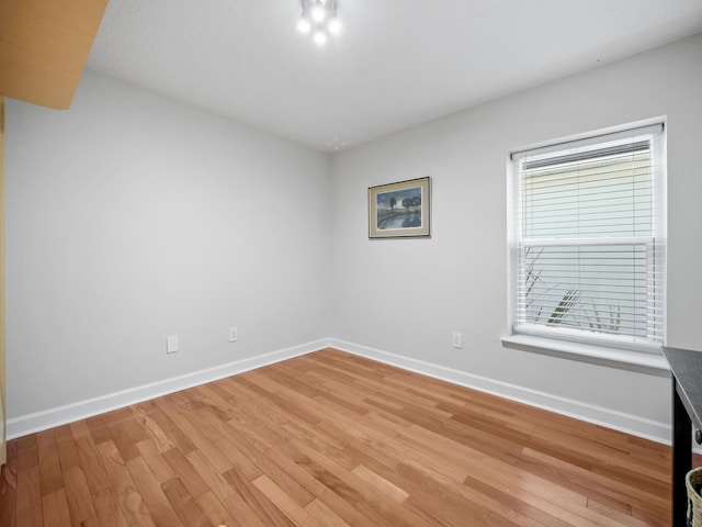 empty room with hardwood / wood-style floors