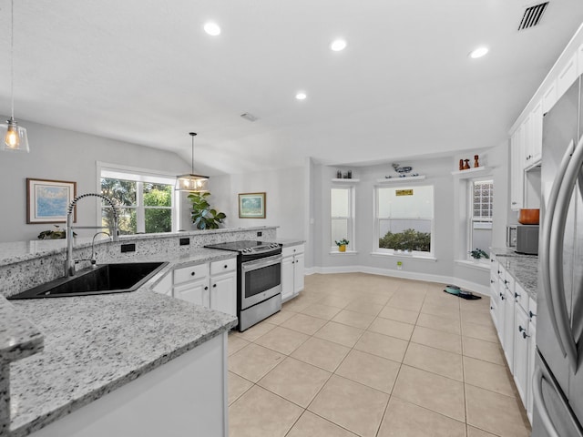 kitchen featuring electric stove, sink, white cabinetry, light stone countertops, and decorative light fixtures