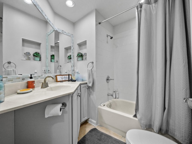 full bathroom with backsplash, vanity, shower / tub combo, toilet, and tile patterned floors