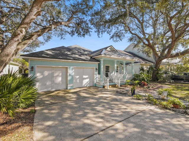 view of front of home with covered porch and a garage