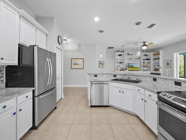 kitchen featuring white cabinetry, sink, light stone counters, and appliances with stainless steel finishes