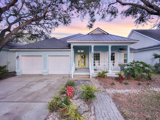 view of front of house with a garage and a porch