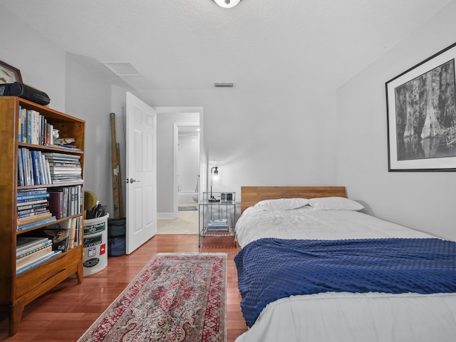 bedroom with hardwood / wood-style flooring