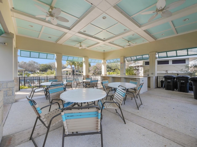 interior space with coffered ceiling and ceiling fan