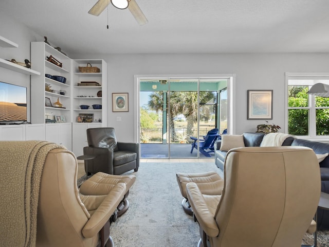 living room with ceiling fan and a healthy amount of sunlight