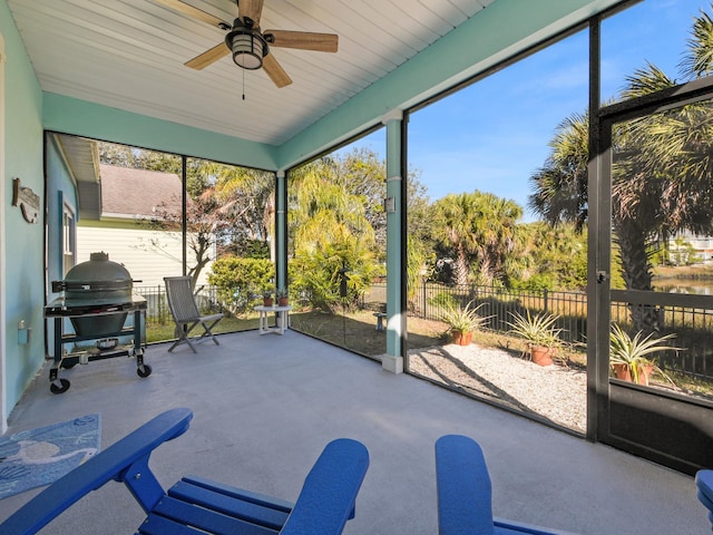 sunroom featuring ceiling fan and a healthy amount of sunlight