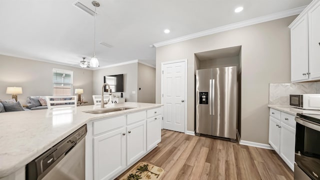 kitchen with white cabinets, appliances with stainless steel finishes, and sink