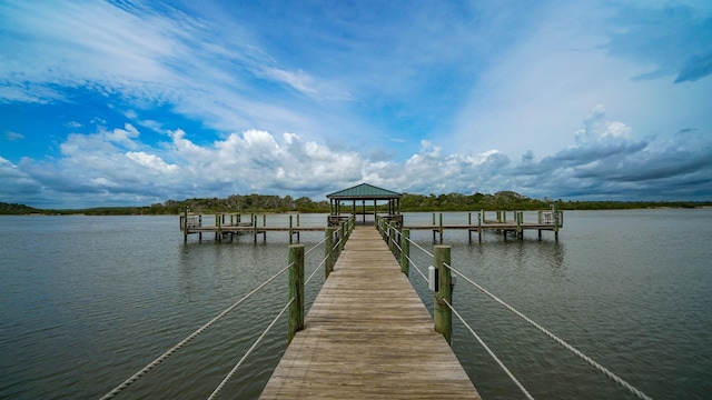 view of dock featuring a gazebo and a water view