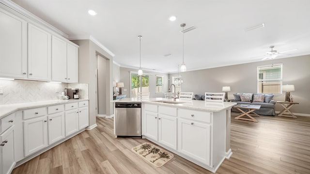 kitchen with stainless steel dishwasher, light wood-type flooring, white cabinetry, and sink