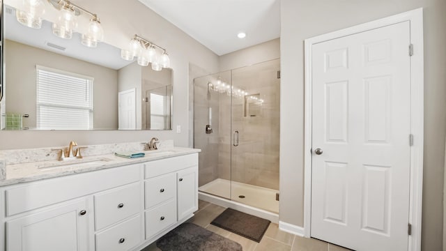 bathroom featuring tile patterned flooring, vanity, and an enclosed shower