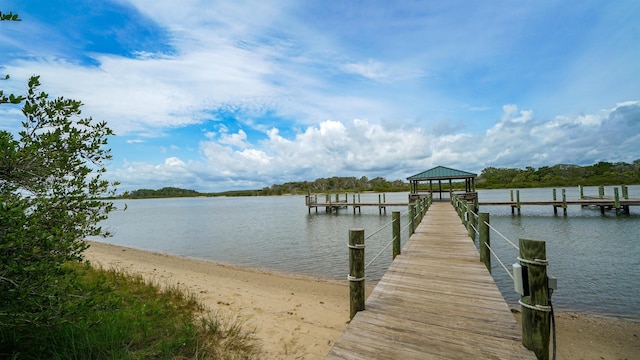 view of dock with a gazebo and a water view