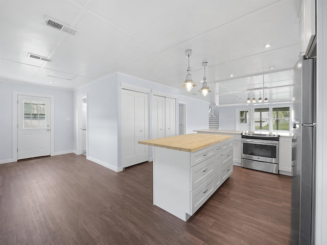 kitchen featuring wood counters, white cabinets, dark hardwood / wood-style floors, and appliances with stainless steel finishes