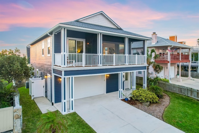 5813 Rudolph Ave, Saint Augustine, FL 32080 - view of front of property with driveway, fence, an attached garage, a sunroom, and a lawn