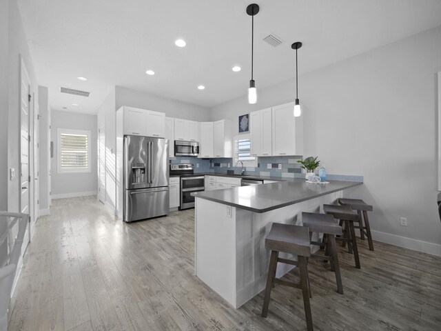 5813 Rudolph Ave, Saint Augustine, FL 32080 - kitchen featuring a sink, a peninsula, stainless steel appliances, and visible vents