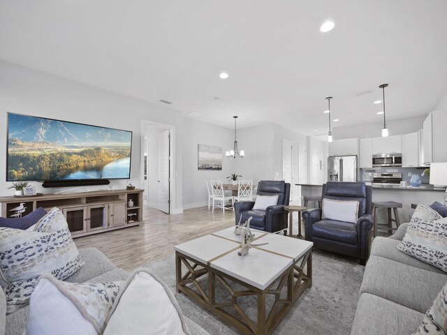 5813 Rudolph Ave, Saint Augustine, FL 32080 - living area featuring an inviting chandelier, light wood-style flooring, baseboards, and recessed lighting
