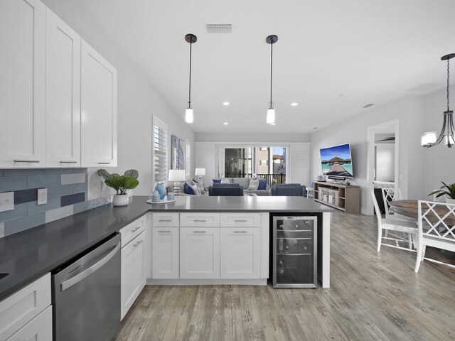 5813 Rudolph Ave, Saint Augustine, FL 32080 - kitchen featuring white cabinetry, a peninsula, stainless steel dishwasher, open floor plan, and beverage cooler